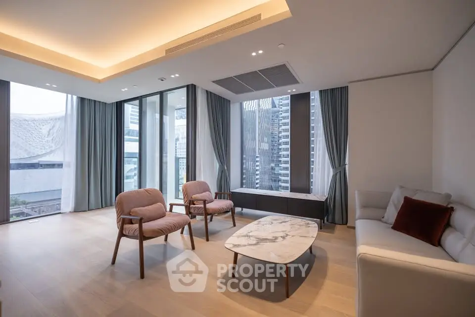 Luxurious modern living room with panoramic city views and elegant furnishings.