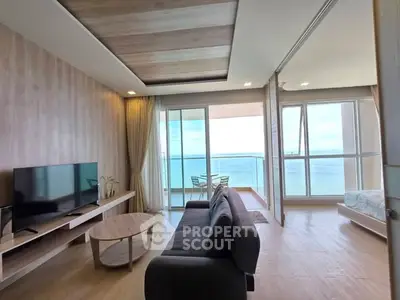 Spacious living room with ocean view and large balcony in modern apartment