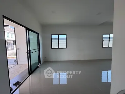 Spacious modern living room with large windows and sleek tile flooring