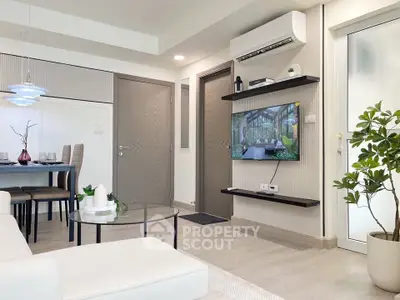 Modern living room with sleek furniture and wall-mounted TV