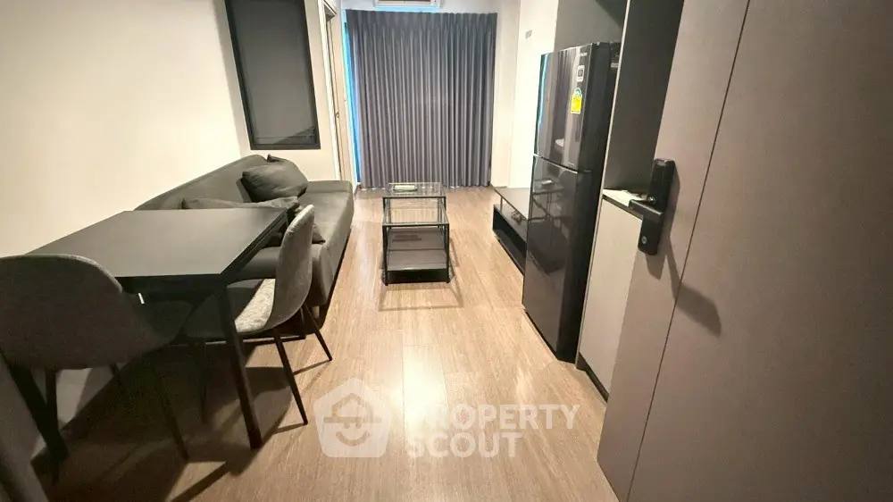 Modern living room with sleek furniture and open kitchen layout