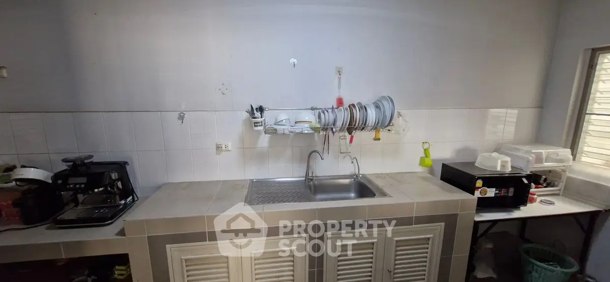 Spacious kitchen with dual sinks and ample counter space, perfect for culinary enthusiasts.