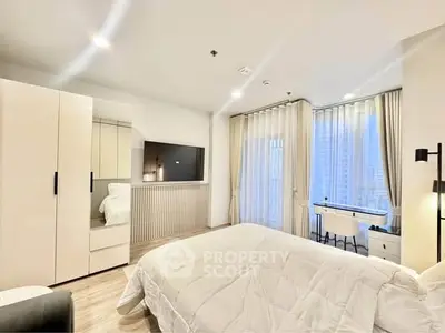 Modern bedroom with sleek design, featuring a cozy bed, large windows, and a stylish desk area.