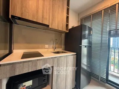 Modern kitchen with sleek appliances and city view from window, perfect for urban living.