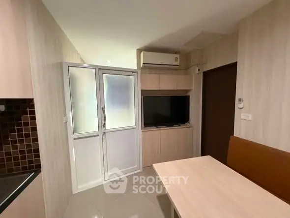 Modern compact living space with sleek design and built-in TV unit