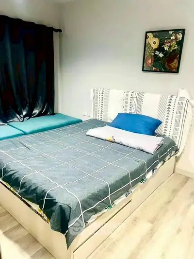 Cozy bedroom with stylish decor and comfortable bedding in modern apartment.