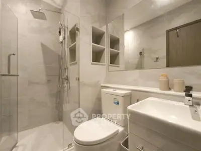 Modern bathroom with sleek shower and elegant fixtures in a contemporary home.