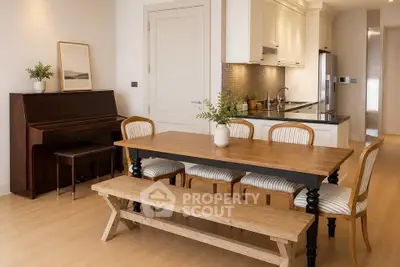 Charming dining area with wooden table, piano, and modern kitchen in open layout apartment.