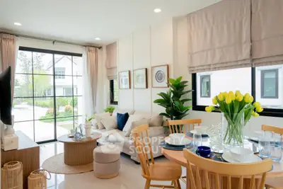 Bright and modern living room with dining area, large windows, and stylish decor.