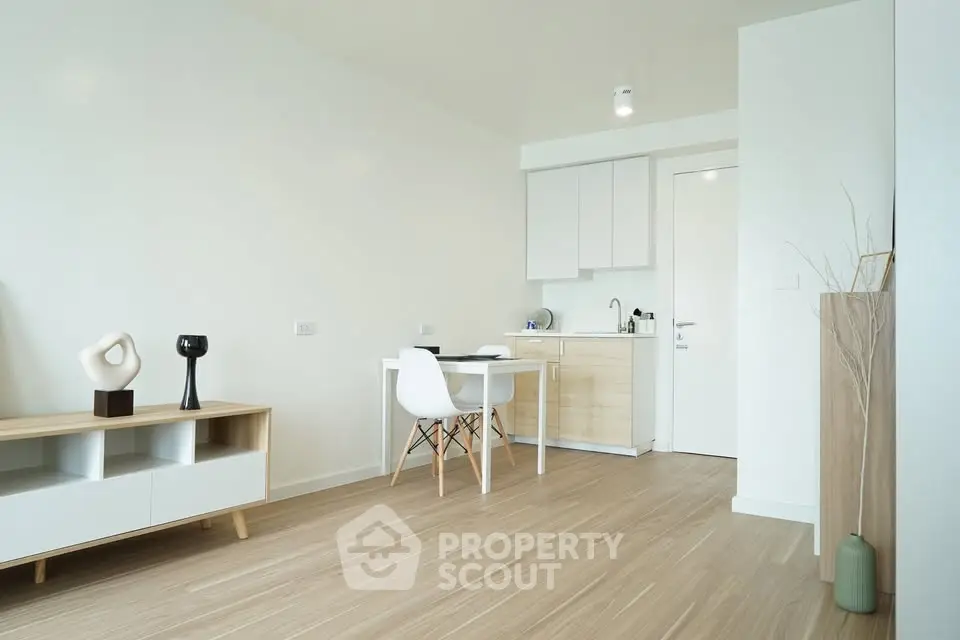 Modern minimalist studio apartment with sleek kitchen and stylish decor