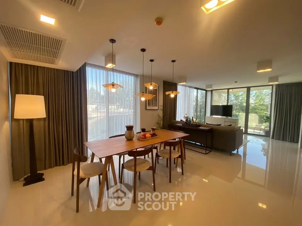 Spacious modern living room with dining area and large windows