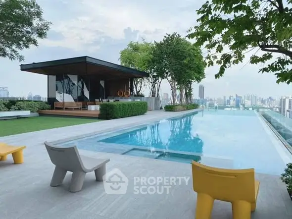 Luxurious rooftop pool with stunning city skyline view and modern seating area.