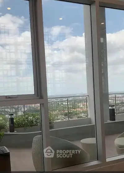 Stunning balcony view with modern seating and expansive cityscape.