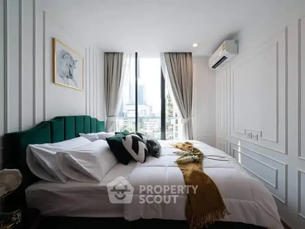 Luxurious bedroom with elegant decor and city view, featuring plush bedding and modern air conditioning.