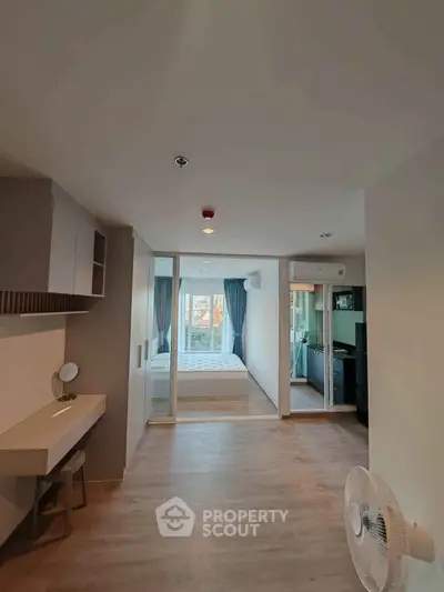 Modern apartment interior with open layout, featuring a bedroom and living area with stylish decor.