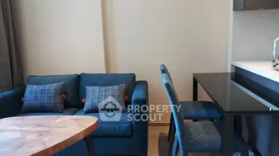 Modern living room with blue sofa and dining area in a stylish apartment