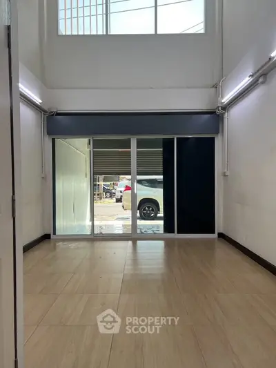 Spacious interior with large windows and sliding glass doors, perfect for natural light and modern living.