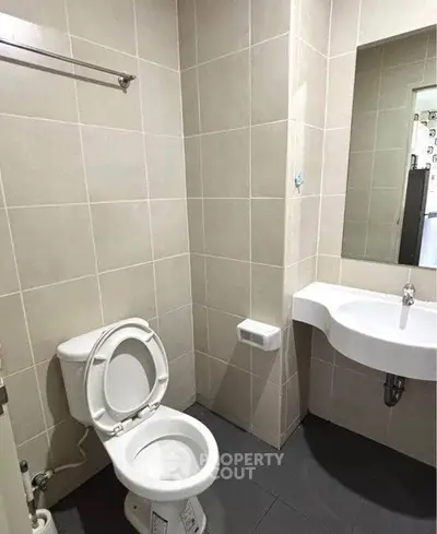 Modern bathroom with sleek fixtures and neutral tiles