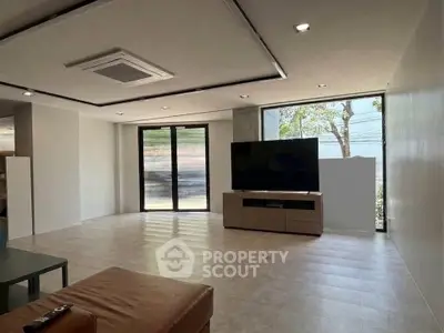 Spacious modern living room with large windows and sleek design