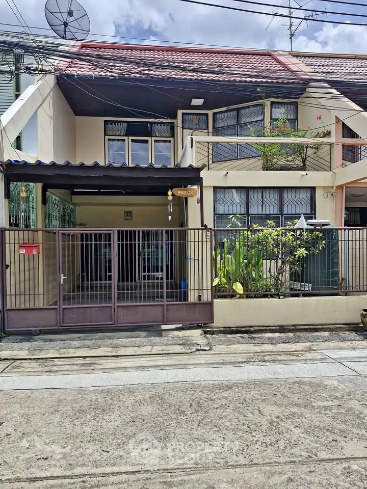 Charming two-story townhouse with gated entrance and balcony in a quiet neighborhood.