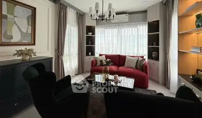 Elegant living room with red sofa, modern decor, and large windows for natural light.