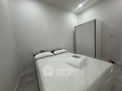 Cozy minimalist bedroom with modern wardrobe and comfortable bed in a serene setting.