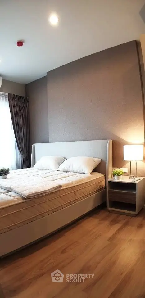 Modern bedroom with cozy lighting and elegant decor in a stylish apartment.