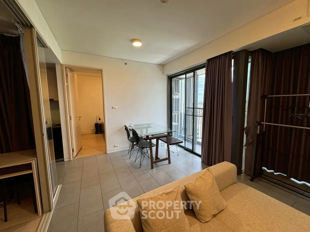 Modern living room with balcony access and stylish furniture