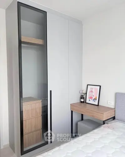 Modern bedroom with sleek wardrobe and stylish desk, perfect for contemporary living.