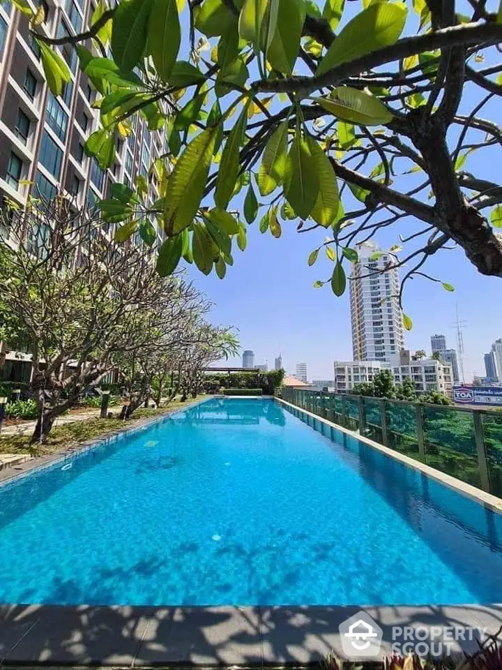 Luxurious rooftop pool with stunning city skyline view, perfect for relaxation and leisure.