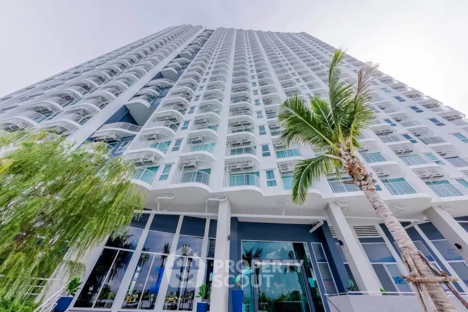 Stunning high-rise building with modern architecture and lush palm trees