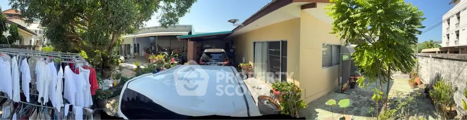 Charming residential property with spacious outdoor area and lush greenery.