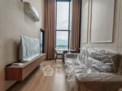 Luxurious living room with high ceilings and stunning view through large windows.