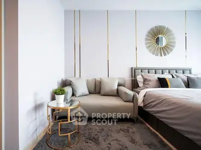 Luxurious bedroom with stylish decor and cozy seating area, perfect for relaxation.