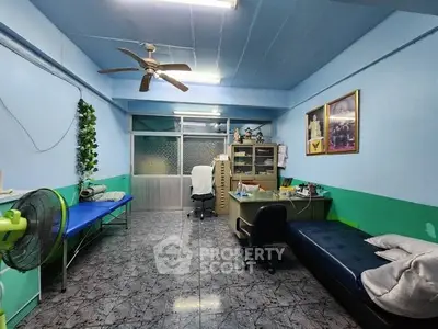 Spacious room with office setup and modern decor, ideal for home office or study area.
