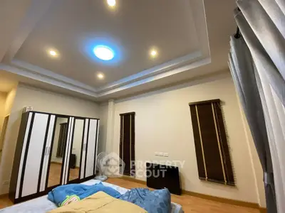 Spacious bedroom with modern ceiling lights and large wardrobe