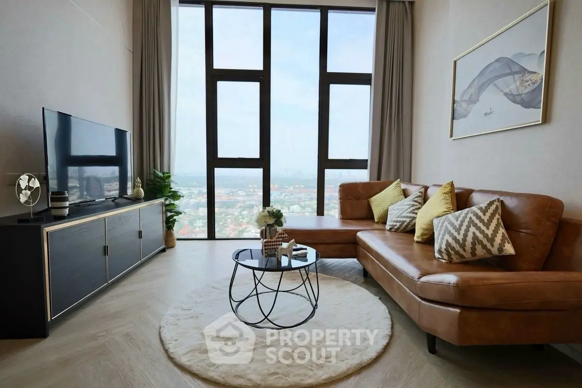Luxurious living room with stunning city view, modern decor, and elegant furniture in high-rise apartment.