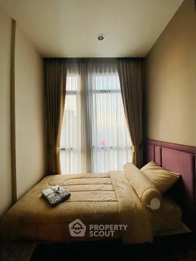Cozy bedroom with elegant curtains and plush bedding, perfect for relaxation and comfort.