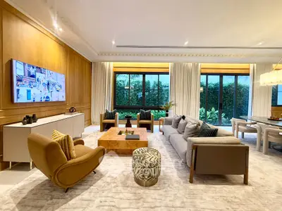 Luxurious living room with elegant decor, large windows, and stylish furniture in a modern home.