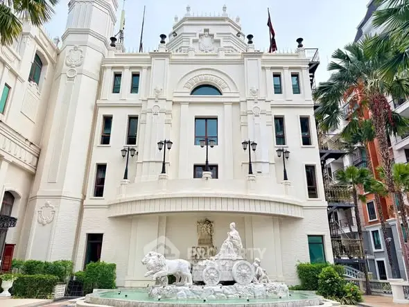 Stunning architectural building with classic facade and elegant fountain in front, surrounded by lush greenery.