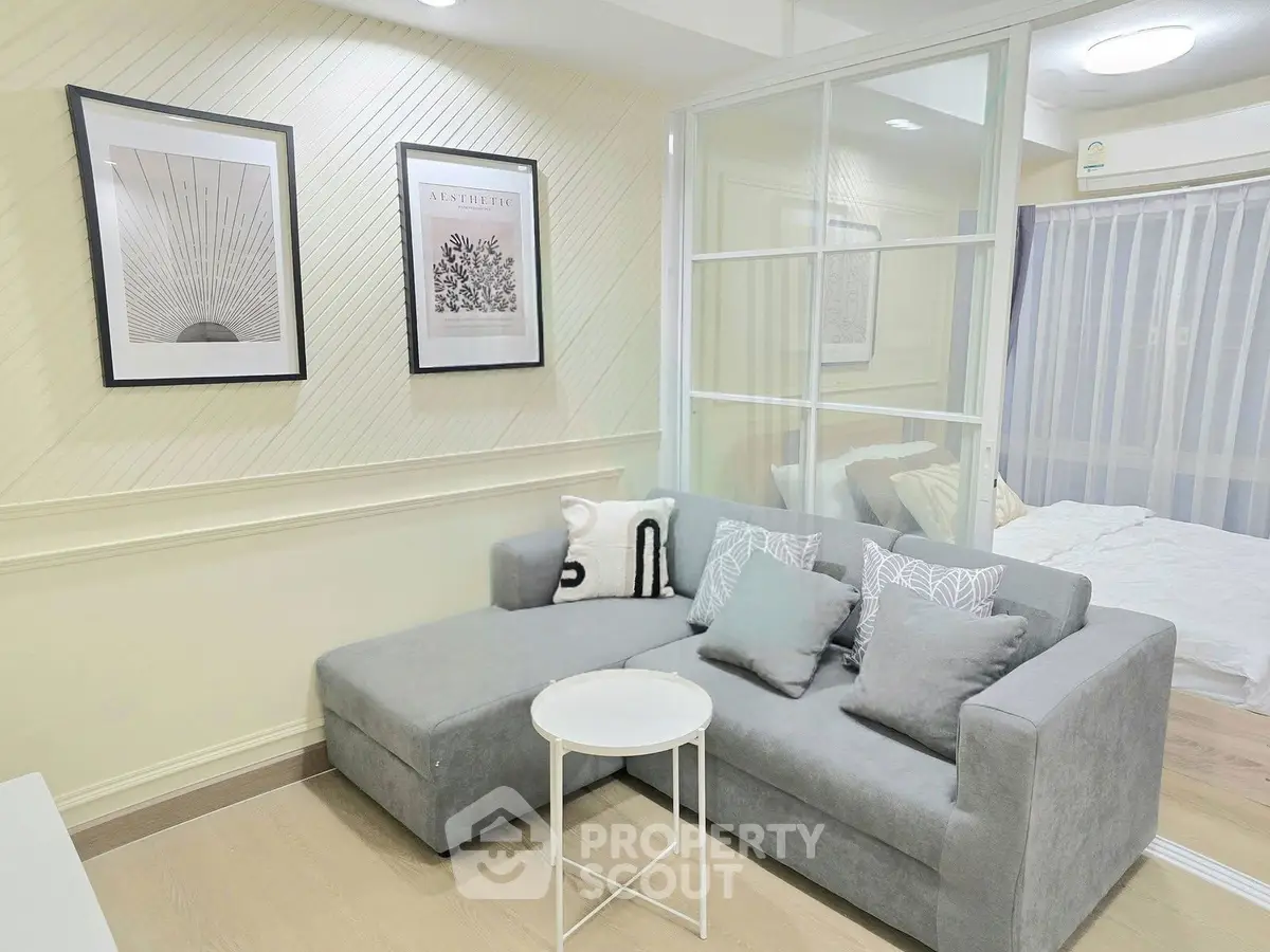 Modern living room with gray sofa and stylish decor in a cozy apartment.
