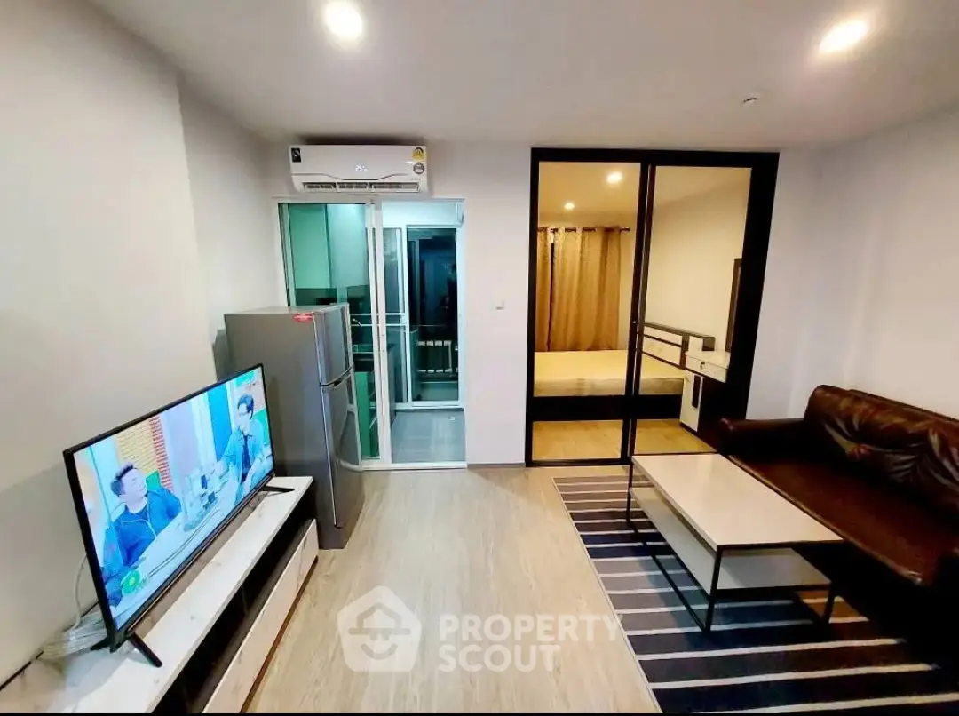 Modern living room with sleek furniture and open layout in a stylish apartment.