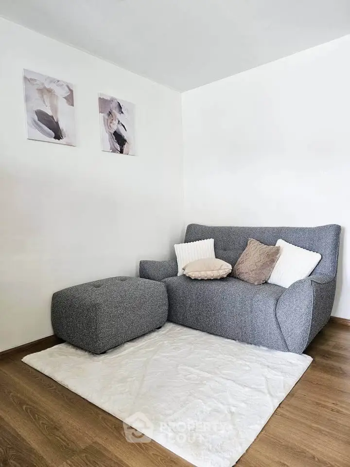 Cozy living room corner with modern gray sofa and stylish decor