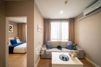 Modern living room with cozy sofa and bedroom view in stylish apartment