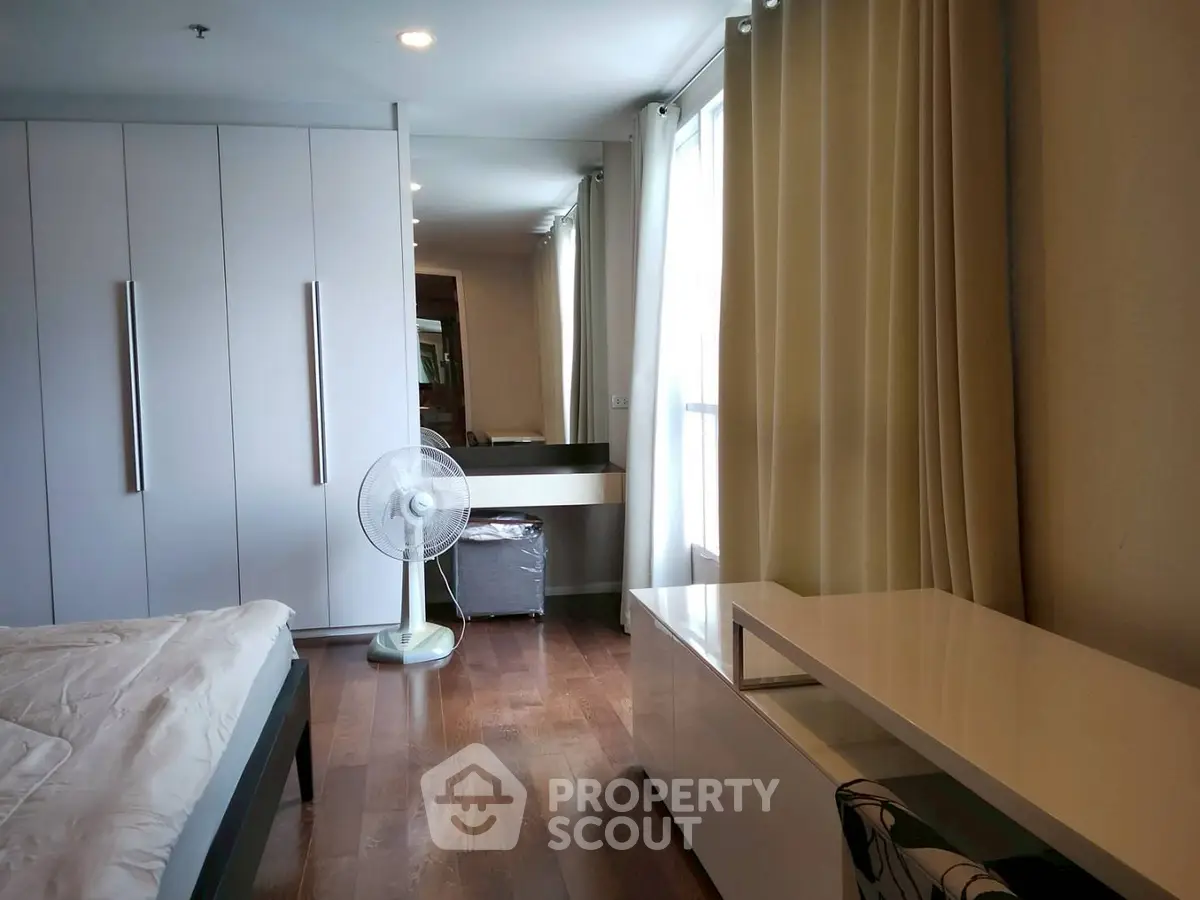 Spacious bedroom with modern decor and ample natural light