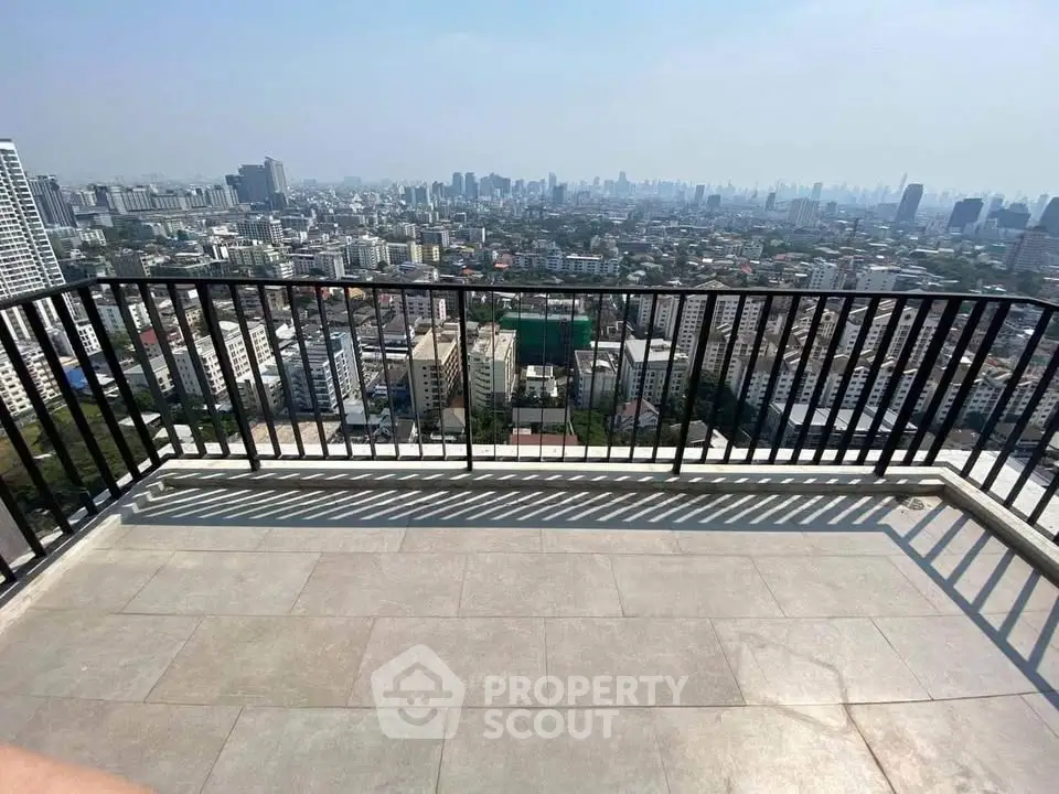 Stunning cityscape view from a spacious balcony in a high-rise building, perfect for urban living.
