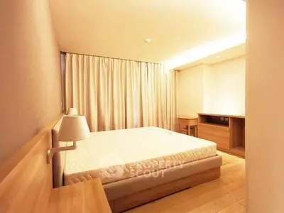 Spacious bedroom with modern wooden furniture and ambient lighting