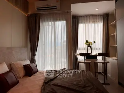Cozy bedroom with city view, modern decor, and natural light