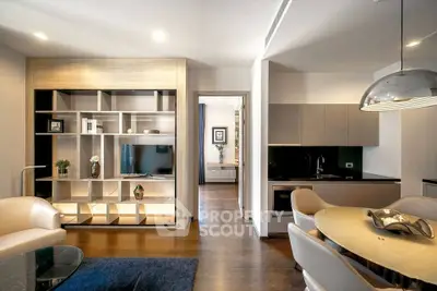 Modern open-plan living room and kitchen with sleek furniture and stylish decor.