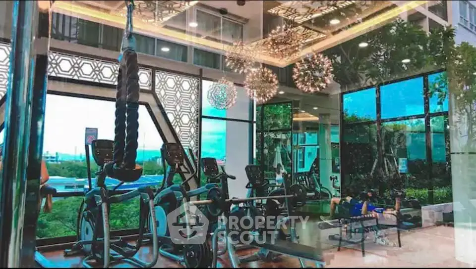Luxurious gym with modern equipment and stunning outdoor views in a high-end residential building.